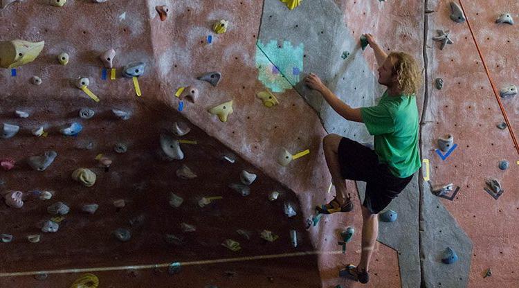 Student climbs a climbing wall on Auraria Campus